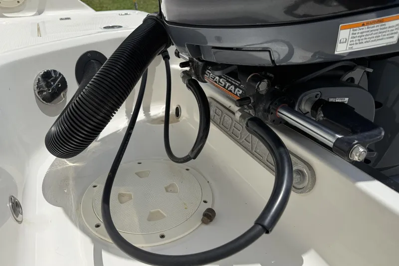 Slide: The Image of 2020 Robalo R230 Center Console boat engine compartment with SeaStar hydraulic steering. - 52