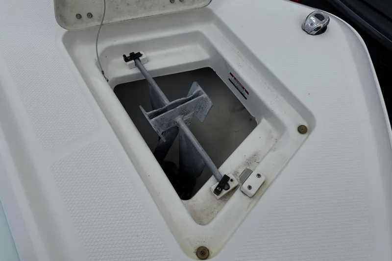Slide: The Image of Anchor compartment of 2020 Robalo R230 Center Console boat, featuring a secured anchor. - 34