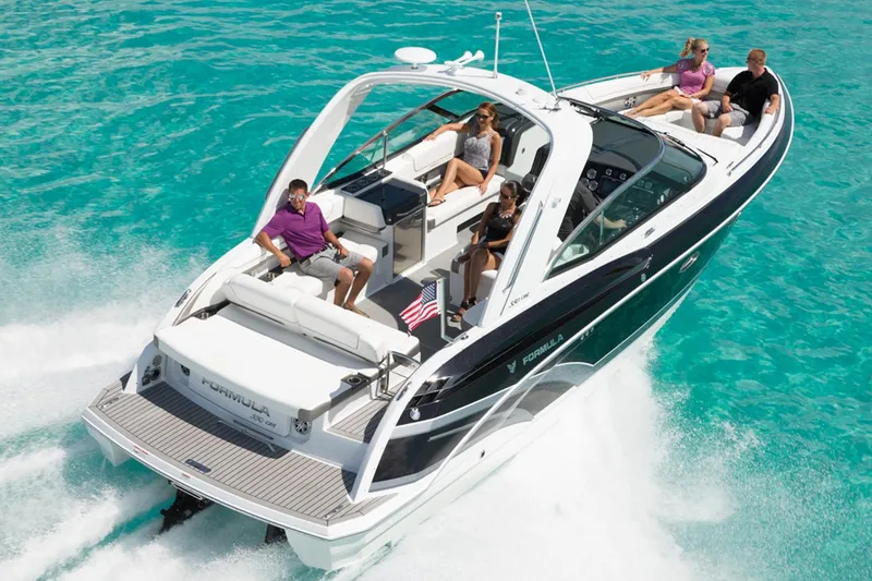Slide: The Image of Manufacturer Provided Image: 2016 Formula 330 Crossover Bowrider cruising on turquoise water with passengers. - 9