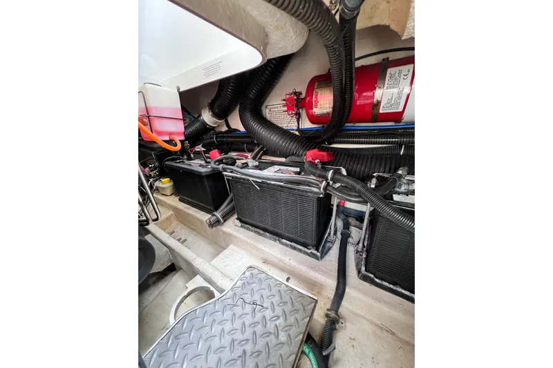 Slide: The Image of Engine compartment of a 2015 Formula 330 Crossover Bowrider with batteries and fire extinguisher. - 13
