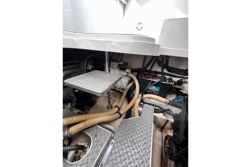 Slide: The Image of Engine compartment of a 2015 Formula 330 Crossover Bowrider with hoses and battery visible. - 17