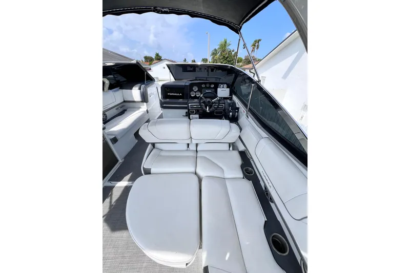 Slide: The Image of 2015 Formula 330 Crossover Bowrider interior with white seating and modern dashboard. - 26
