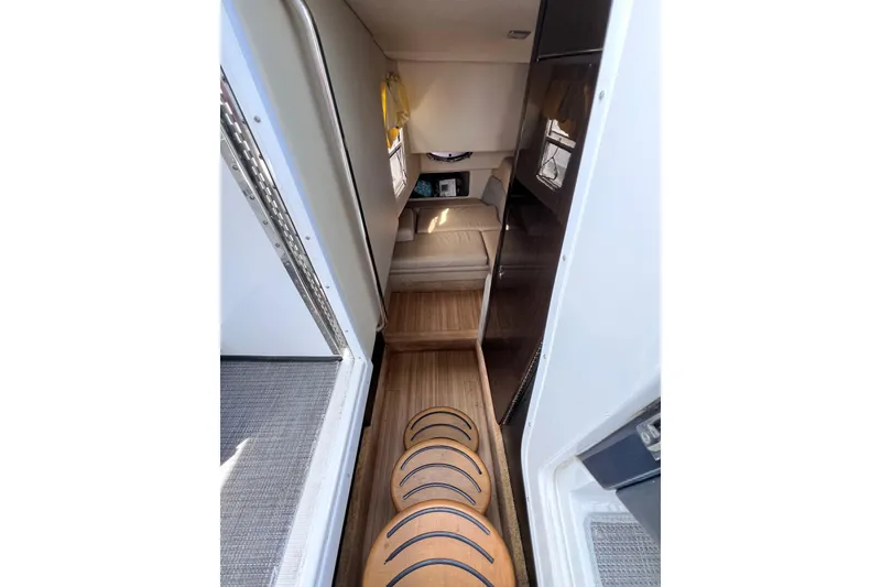 Slide: The Image of Interior view of 2015 Formula 330 Crossover Bowrider with wooden steps and cozy seating area. - 20