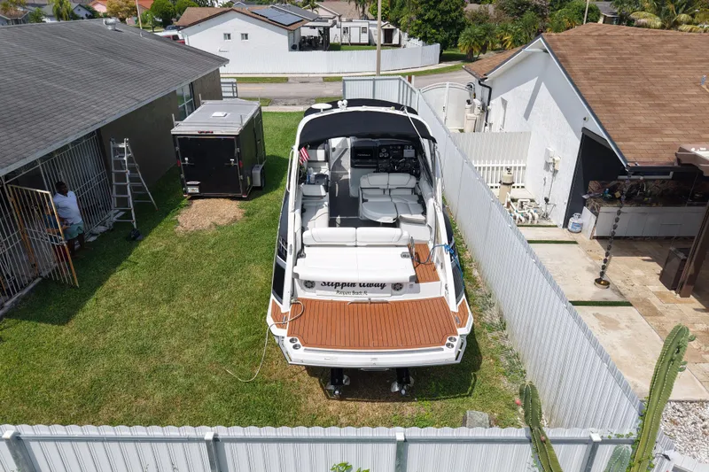 Slide: The Image of 2015 Formula 330 Crossover Bowrider parked in a residential backyard. - 3