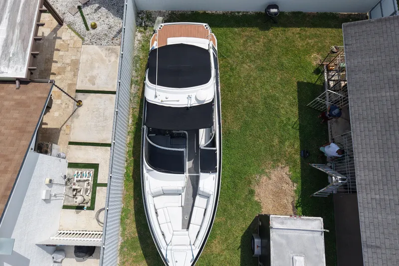 Slide: The Image of Overhead view of a 2015 Formula 330 Crossover Bowrider parked on grass. - 6