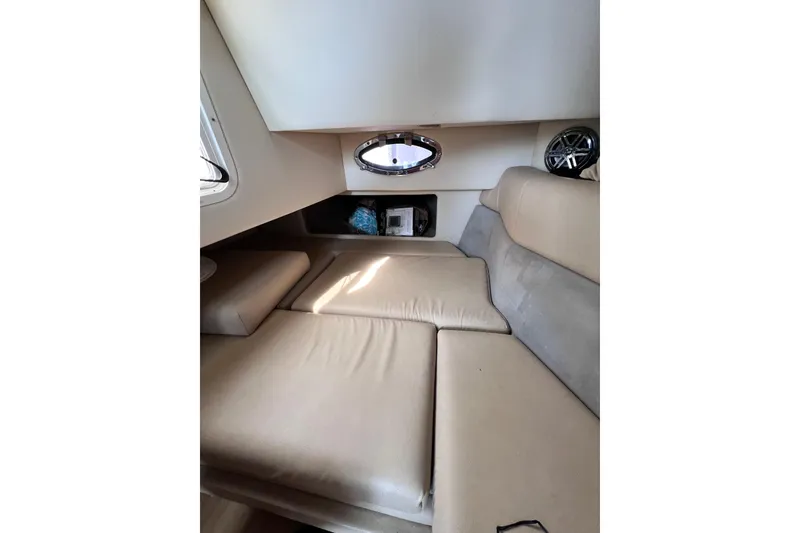 Slide: The Image of Interior cabin of 2015 Formula 330 Crossover Bowrider with beige seating and porthole window. - 22