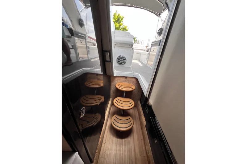 Slide: The Image of Interior view of 2015 Formula 330 Crossover Bowrider with wooden steps and sleek design. - 23