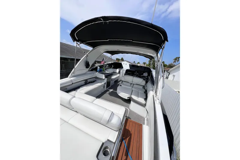 Slide: The Image of 2015 Formula 330 Crossover Bowrider with spacious seating and sleek design under a sunny sky. - 27