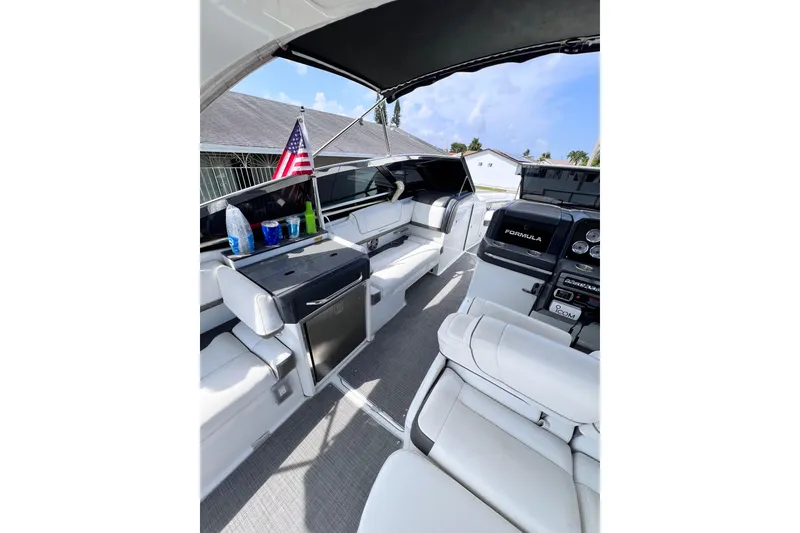 Slide: The Image of 2015 Formula 330 Crossover Bowrider interior with seating, dashboard, and American flag. - 25
