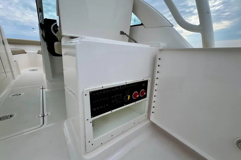 Slide: The Image of 2016 Pursuit DC 265 Dual Console boat interior with control panel and seating. - 14