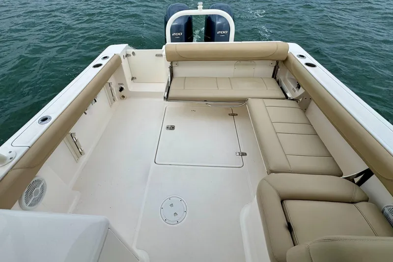 Slide: The Image of 2016 Pursuit DC 265 Dual Console boat with spacious seating and twin 200 engines on water. - 12
