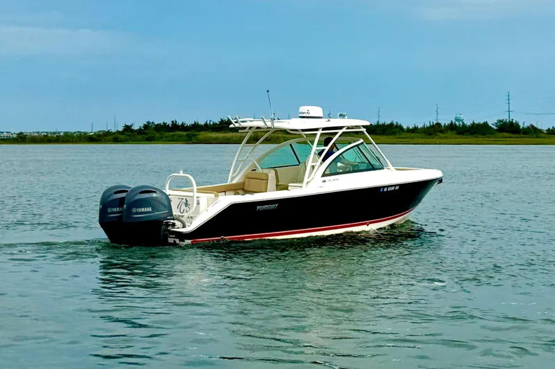 Slide: The Image of 2016 Pursuit DC 265 Dual Console boat cruising on calm waters with twin Yamaha engines. - 3
