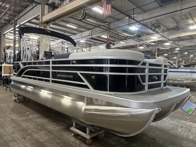 The Image of A Bennington 22 S1 Fish and Cruise pontoon boat in a warehouse setting. - 1