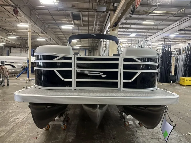 The Image of A Bennington 22 S1 Fish and Cruise pontoon boat in a warehouse setting. - 1