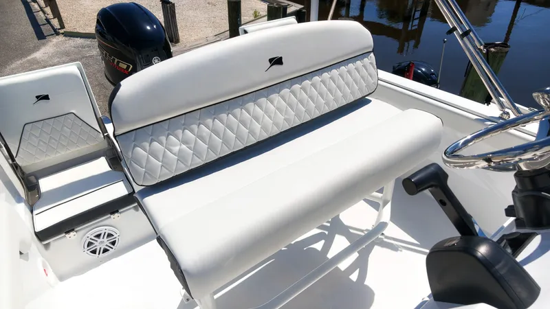 Slide: The Image of The image shows the white upholstery of boat seats with a quilted pattern. - 15
