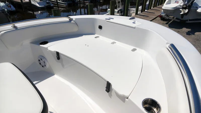 Slide: The Image of The image shows the cockpit of a 2027 Stingray 17 CC boat with white seating and stainless steel railings. - 15