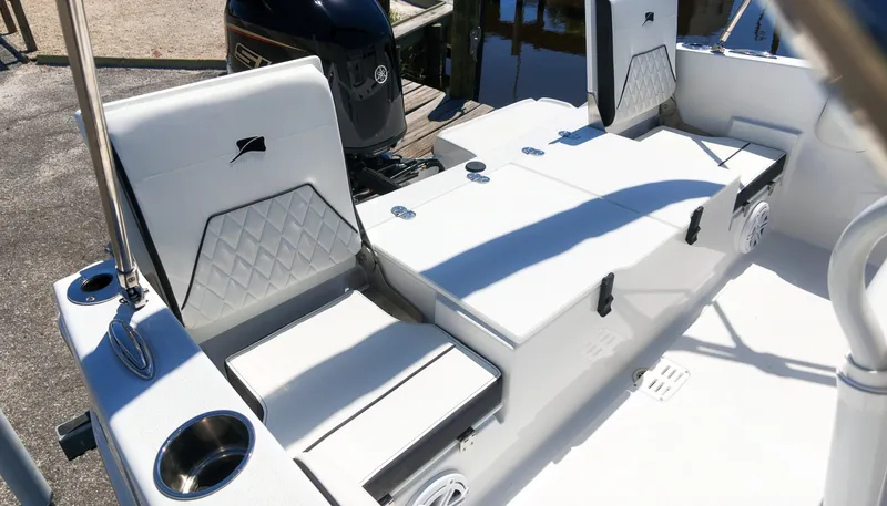 Slide: The Image of The image shows the interior of a 2027 Stingray 17 CC boat with white upholstery. - 5
