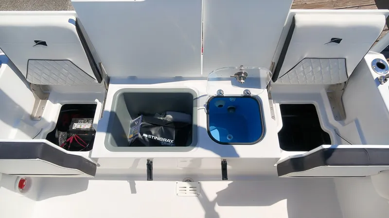 Slide: The Image of The image shows the cockpit of a Stingray 17 CC boat with storage compartments and a sink. - 9