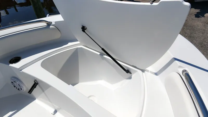 Slide: The Image of The image shows an open storage compartment on a boat, featuring a hydraulic lift arm. - 16