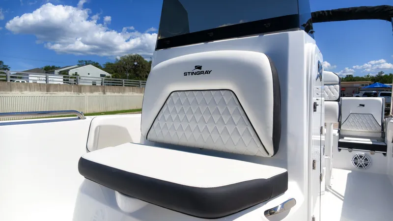 Slide: The Image of The image shows the cockpit of a 2027 Stingray 17 CC boat with white upholstery. - 18