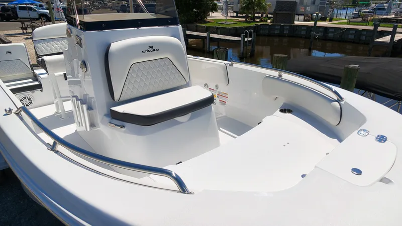 Slide: The Image of The image shows a modern Stingray 17 CC boat with white interior and sleek details. - 6