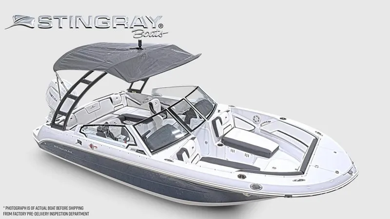 The Image of The image shows a modern Stingray 20 SBX boat with a gray canopy and sleek design. - 1