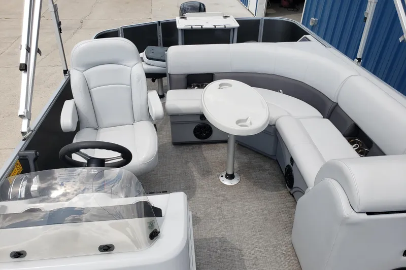 Slide: The Image of 2023 Bentley Pontoons 223 4 Party Fish interior with plush seating and steering console. - 6