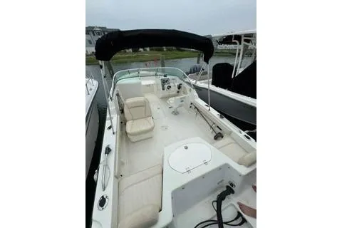 Slide: The Image of 2007 Hydra-Sports Lightning 202 DC boat with open deck and seating, docked near water. - 5