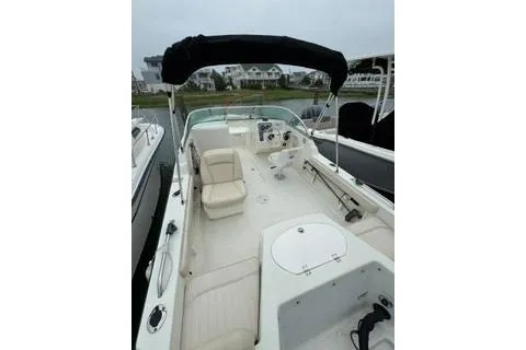 Slide: The Image of 2007 Hydra-Sports Lightning 202 DC boat with seating and canopy, docked in a marina. - 6