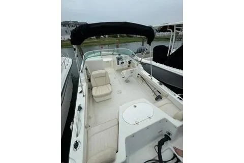 Slide: The Image of 2007 Hydra-Sports Lightning 202 DC boat with open deck and seating, docked by the water. - 7