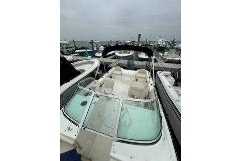 Slide: The Image of 2007 Hydra-Sports Lightning 202 DC boat docked at marina under cloudy skies. - 9
