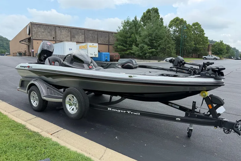 The Image of 2025 Ranger Z518 Cup-Equipped boat on trailer, parked outdoors near industrial building. - 0