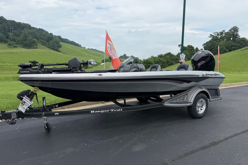 Slide: The Image of 2025 Ranger Z518 Cup-Equipped boat on trailer, parked outdoors with scenic background. - 4
