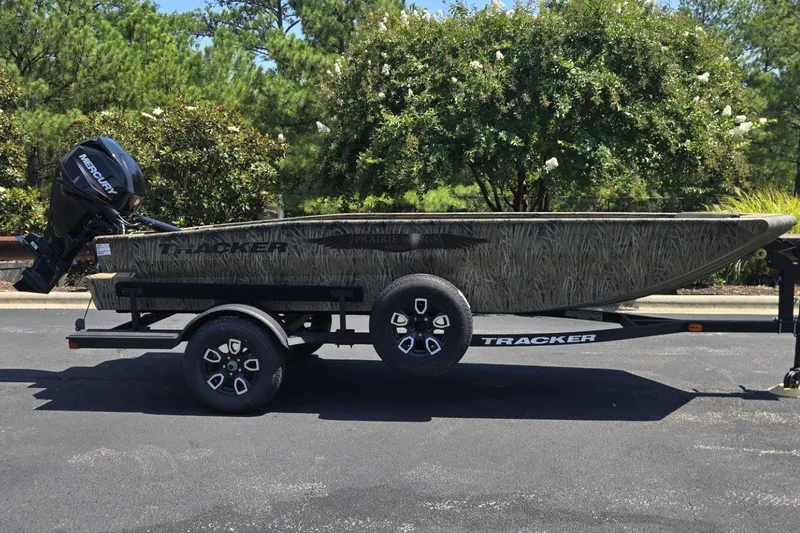 The Image of 2026 Tracker Grizzly 1650 T Prairie Wings Edition boat on trailer, outdoors. - 0