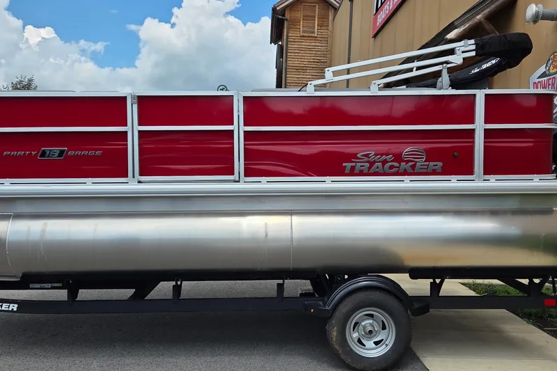 The Image of 2026 Sun Tracker Party Barge 18 DLX pontoon boat with red and silver design. - 0