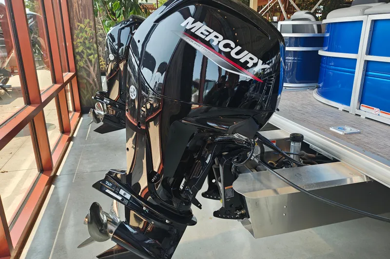 Slide: The Image of 2026 Sun Tracker Party Barge 20 DLX with Mercury outboard motor in showroom. - 14