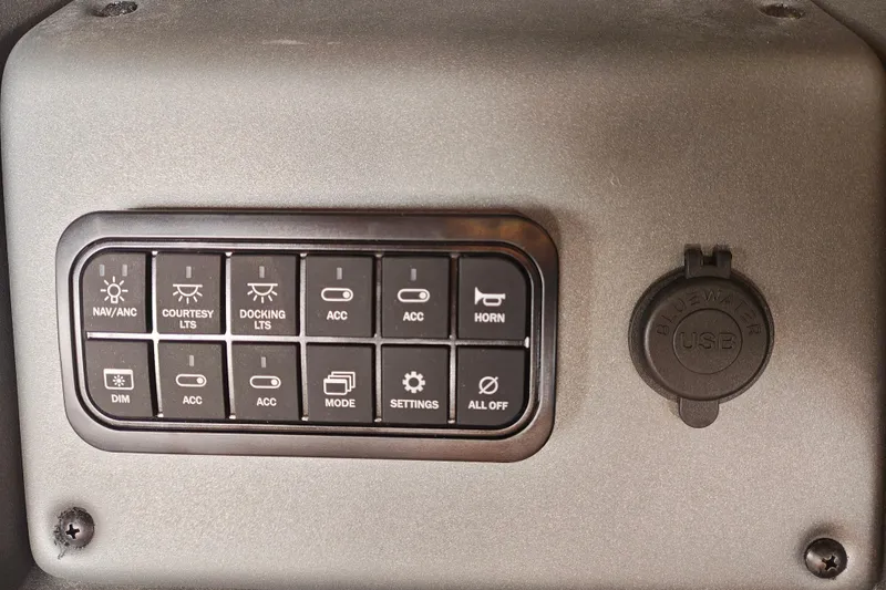 Slide: The Image of Control panel of 2026 Sun Tracker Party Barge 20 DLX with USB port and various switches. - 19