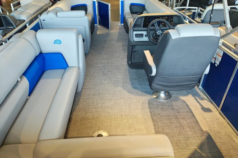 Slide: The Image of 2026 Sun Tracker Party Barge 20 DLX interior with gray and blue seating. - 17