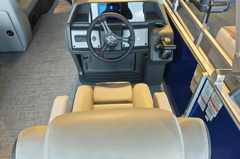 Slide: The Image of Interior view of 2026 Sun Tracker Party Barge 20 DLX helm with steering wheel and controls. - 18