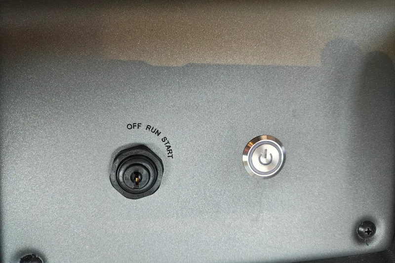 Slide: The Image of Control panel of 2026 Sun Tracker Party Barge 20 DLX with ignition and power button. - 20