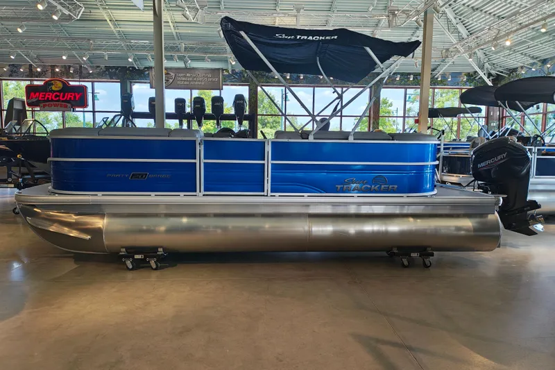 The Image of 2026 Sun Tracker Party Barge 20 DLX pontoon boat displayed indoors. - 1
