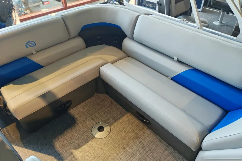 Slide: The Image of 2026 Sun Tracker Party Barge 20 DLX interior seating with gray and blue upholstery. - 12