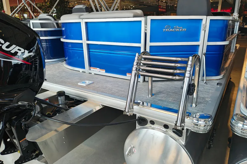 Slide: The Image of 2026 Sun Tracker Party Barge 20 DLX pontoon boat with Mercury engine, blue exterior. - 15