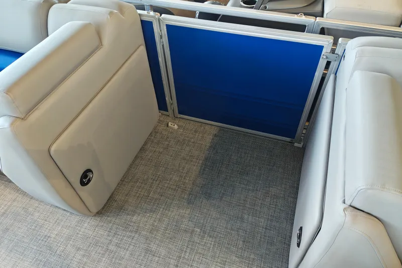Slide: The Image of 2026 Sun Tracker Party Barge 20 DLX interior with gray seating and blue panel. - 10