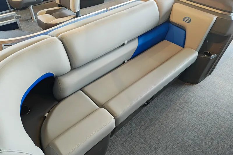 Slide: The Image of 2026 Sun Tracker Party Barge 20 DLX interior seating with gray and blue upholstery. - 6