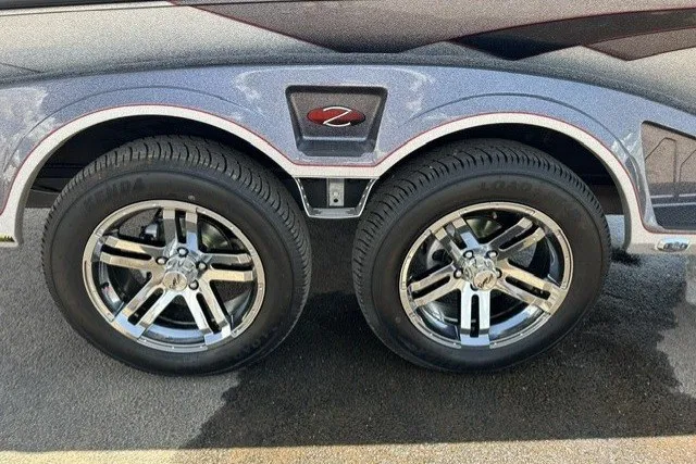 Slide: The Image of 2026 Ranger Z520 trailer with dual chrome wheels on asphalt surface. - 6