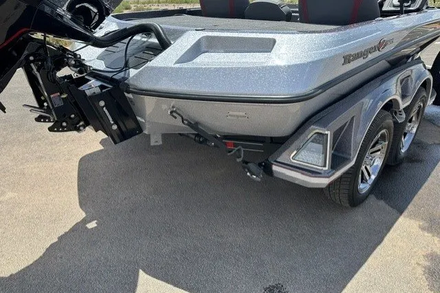 Slide: The Image of 2026 Ranger Z520 boat rear view with dual-axle trailer on pavement. - 2