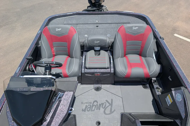 Slide: The Image of 2026 Ranger Z520 boat interior with red and gray seats, steering wheel, and console. - 23