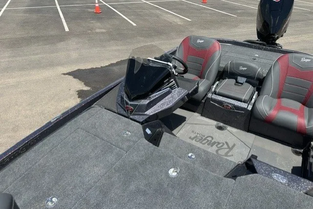 Slide: The Image of 2026 Ranger Z520 boat interior with dual seats and steering console in a parking lot. - 18