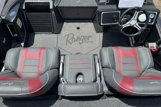 Slide: The Image of 2026 Ranger Z520 boat interior with gray and red seats, steering wheel, and console. - 20